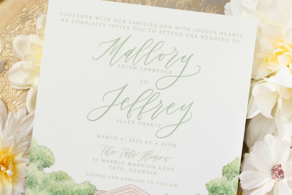 Formal wedding invitation featuring close look at E Stokes Creations signature style of hand-lettered calligraphy of couple's names and the venue location: the Tate House. 