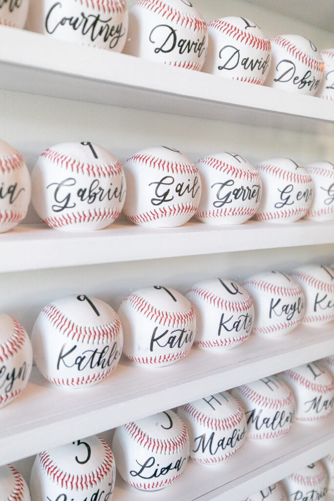 Wedding couple had a baseball wall with guest names and table assignments, acting as the seating chart for the wedding in Tate, Georgia. Atlanta Braves and MLB fans can incorporate this fun concept into their wedding.