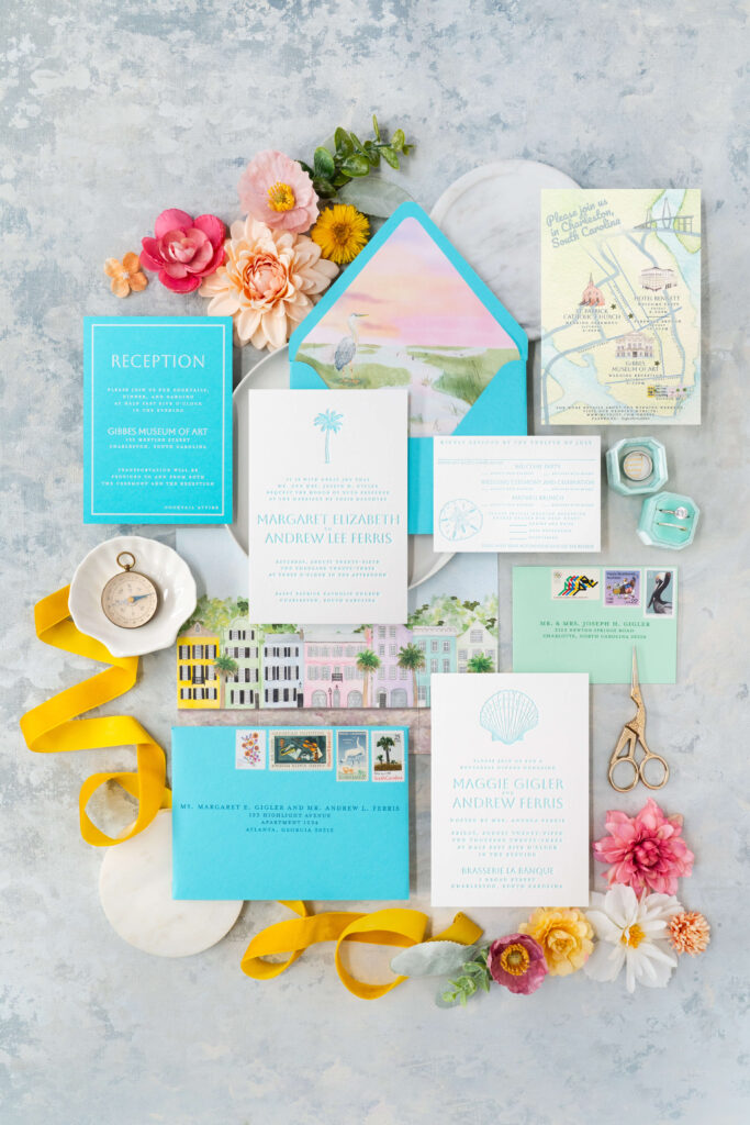 Flat lay photograph of turquoise letterpress custom wedding invitations for a Charleston, South Carolina bride and groom.