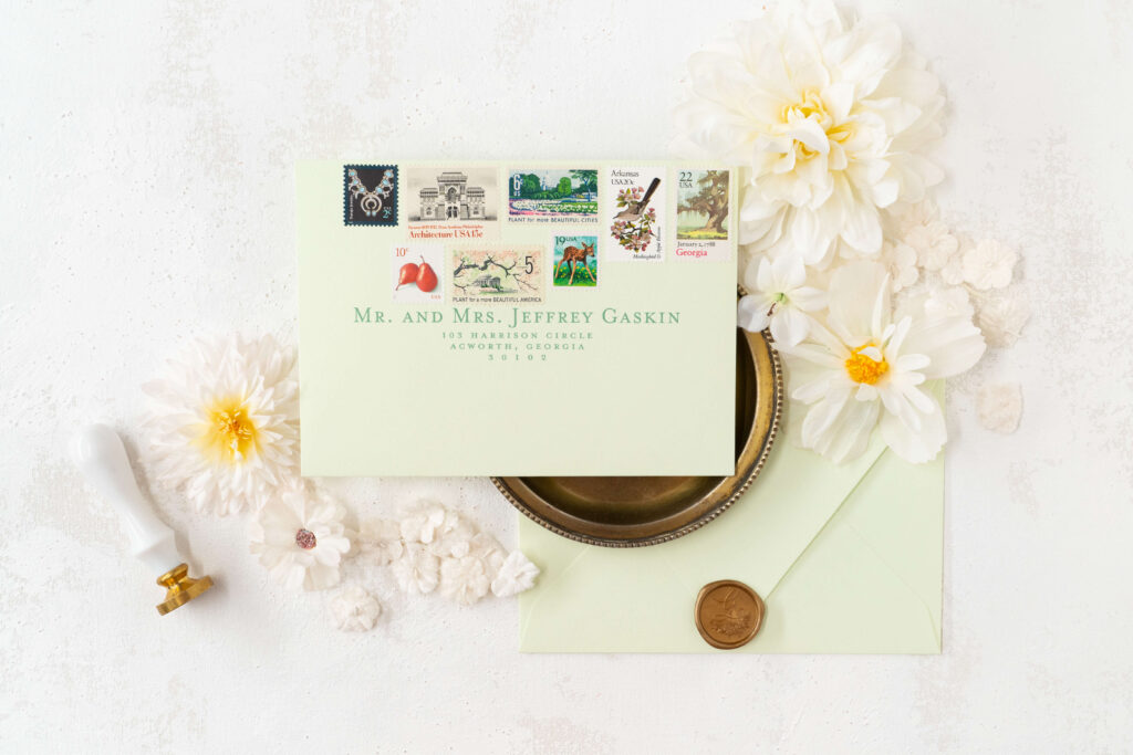 Unique wedding invites with wax seals and vintage stamps.