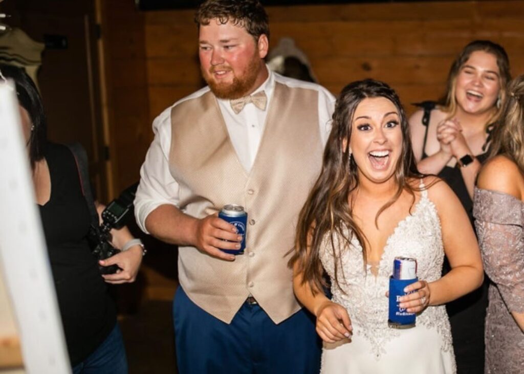 Bride and groom reaction to wedding ceremony painter.